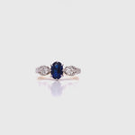 Load and play video in Gallery viewer, 18ct/Platinum Synthetic Sapphire Two Diamond Ring TDW 0.26ct
